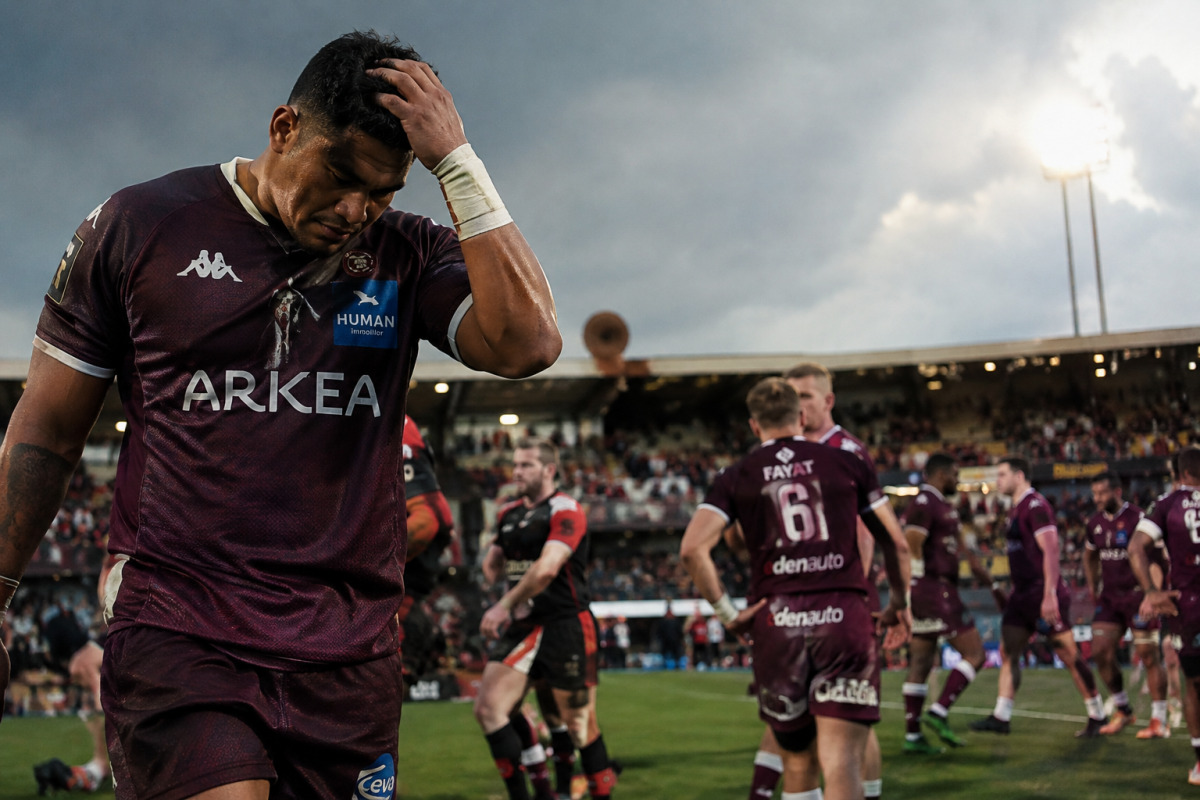 Joueurs de Bordeaux-Bègles en maillot noir et blanc affrontant Gloucester au rugby.
